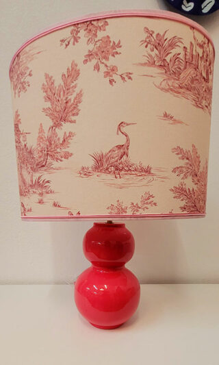 A handmade lampshade with French Toile de Jouy fabric in pink